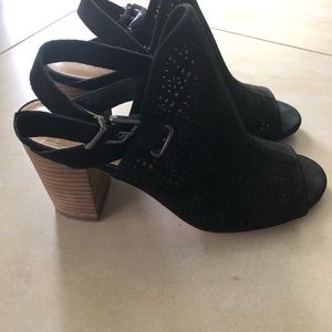 Velvety black shoe with a buckle strap.